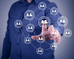 Businessman pressing social media icon