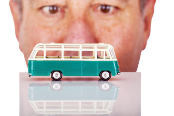Man looks on model buses