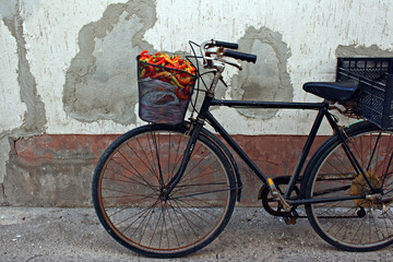 Fototapeta na wymiar Old rusty bicycle with colorful peppers in basket