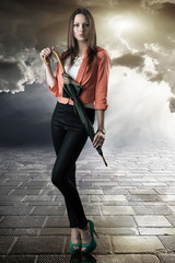 Naklejka premium beautiful woman with closed umbrella