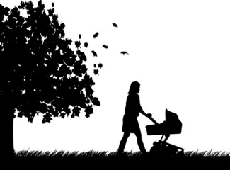 A young mother pushing the stroller and walk through the park
