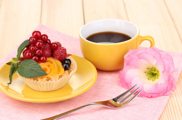 Dulcet cake with fruit and berries on wooden table