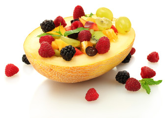fresh fruits salad in melon  and berries, isolated on white