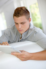 Young man using electronic tablet at home
