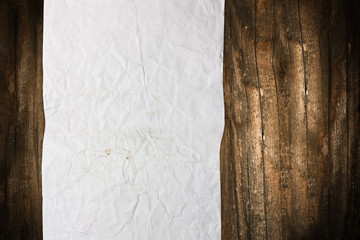 Torn blank paper roll on a wooden background