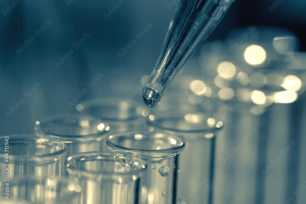 Wall mural pipette adding fluid to one of several test tubes