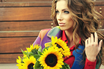Fashion woman with sunflower at outdoor.