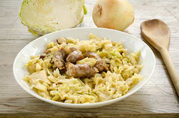 Cooked pork sausage and boiled cabbage