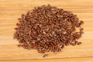 flax seeds on wooden background close-up