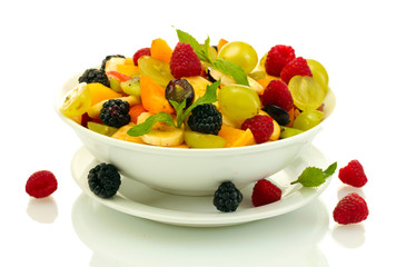 fresh fruits salad in bowl  and berries, isolated on white