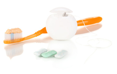Toothbrush, chewing gum and dental floss isolated on white