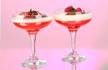fruit jelly with berries in glasses on pink background