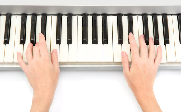 hands of woman playing piano