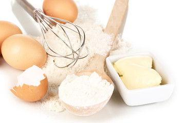 Eggs, flour and butter isolated on white