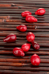 fresh cornel berries on bamboo mat