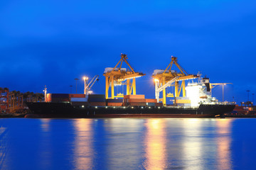Fototapeta na wymiar Containers loading at sea trading port at Twilight
