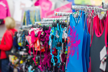 Fototapeta na wymiar Swimsuits and bikinis on stands in supermarket