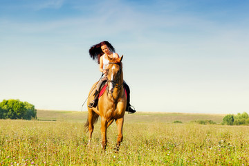 Beautiful girl riding a horse in countryside