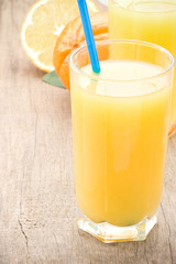 fresh fruits orange juice in glass on wood board
