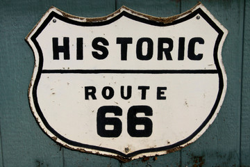 Old historic route 66 sign on the wall - Powered by Adobe
