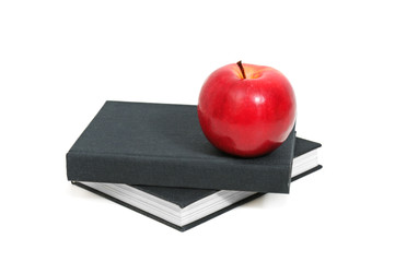red apple on a book isolated on white background