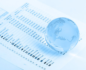 Glass globe and pen on finance