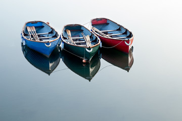 Fototapeta na wymiar Red, Green and Blue Rowing Boats