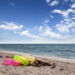 Young couple relaxing on a warm tropical sand