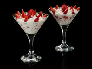 Strawberry with cream in two glasses.
