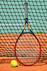Tennis ball and racket on the court