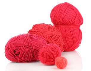 Red knittings yarns isolated on white