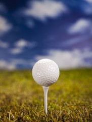 Golf ball on green meadow 