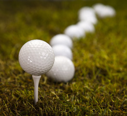 Golf ball on green meadow 