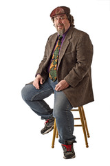 Smiling large man sits in relaxed pose