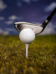 Golf club and ball in grass 