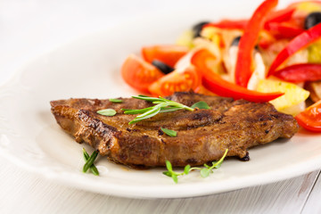 Grilled pork steak with salad