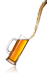 Pouring beer into glass, isolated on white background