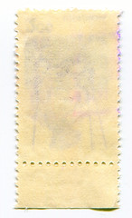 The reverse side of a postage stamp.
