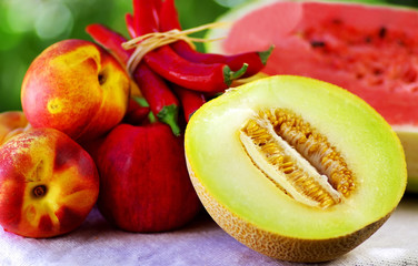 Half of melon. Chili and fruits