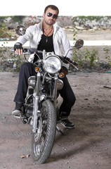 Fototapeta na wymiar Good looking young man on motorcycle