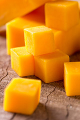 Cheese cubes on wooden background