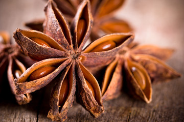 Anise stars on wooden background