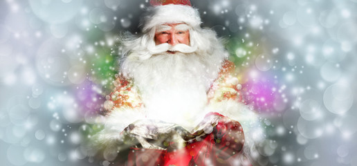 Santa sitting at the Christmas room and looking into the sack