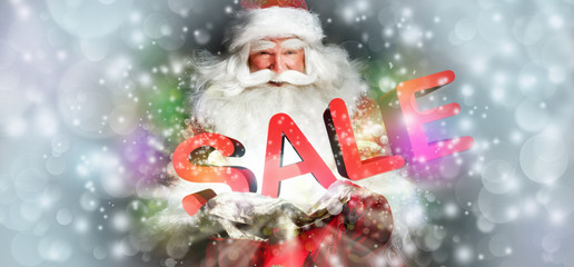 Santa Claus holding his bag and smiling. Lights and sparks are f