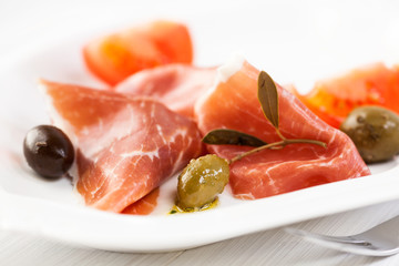 Serrano ham with marinated olives