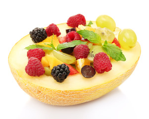 fresh fruits salad in melon, isolated on white