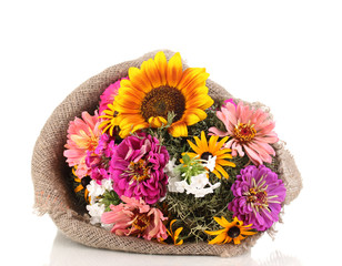 Beautiful bouquet of bright flowers in sacking isolated on