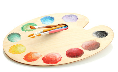 wooden art palette with paint and brushes isolated on white