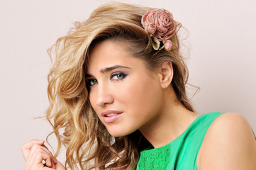 Beautiful blonde woman in green dress.