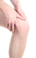 man holding sore knee, isolated on white
